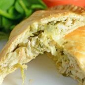 Artichoke Chicken Pot Pie is an easy hand pie recipe stuffed with shredded chicken, artichokes, spinach, red onion, cheese and zesty Italian dressing. #chickenpotpie #handpies www.savoryexperiments.com