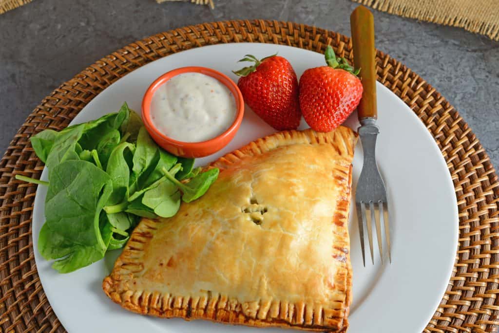 Artichoke Chicken Pot Pie is an easy hand pie recipe stuffed with shredded chicken, artichokes, spinach, red onion, cheese and zesty Italian dressing. #chickenpotpie #handpies www.savoryexperiments.com