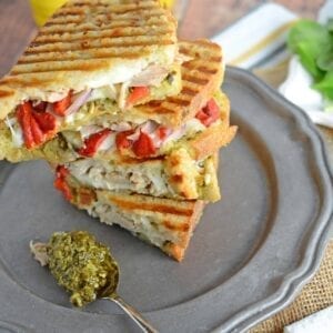 Italian Chicken Panini Recipe - Crusty bread filled with gooey mozzarella cheese, roasted red pepper, shredded chicken and lots and lots of garlicky pesto. www.savoryexperiments.com