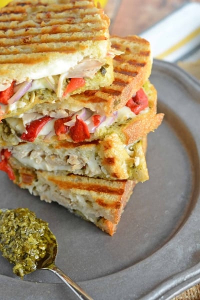 Italian Chicken Panini Recipe - Crusty bread filled with gooey mozzarella cheese, roasted red pepper, shredded chicken and lots and lots of garlicky pesto. www.savoryexperiments.com