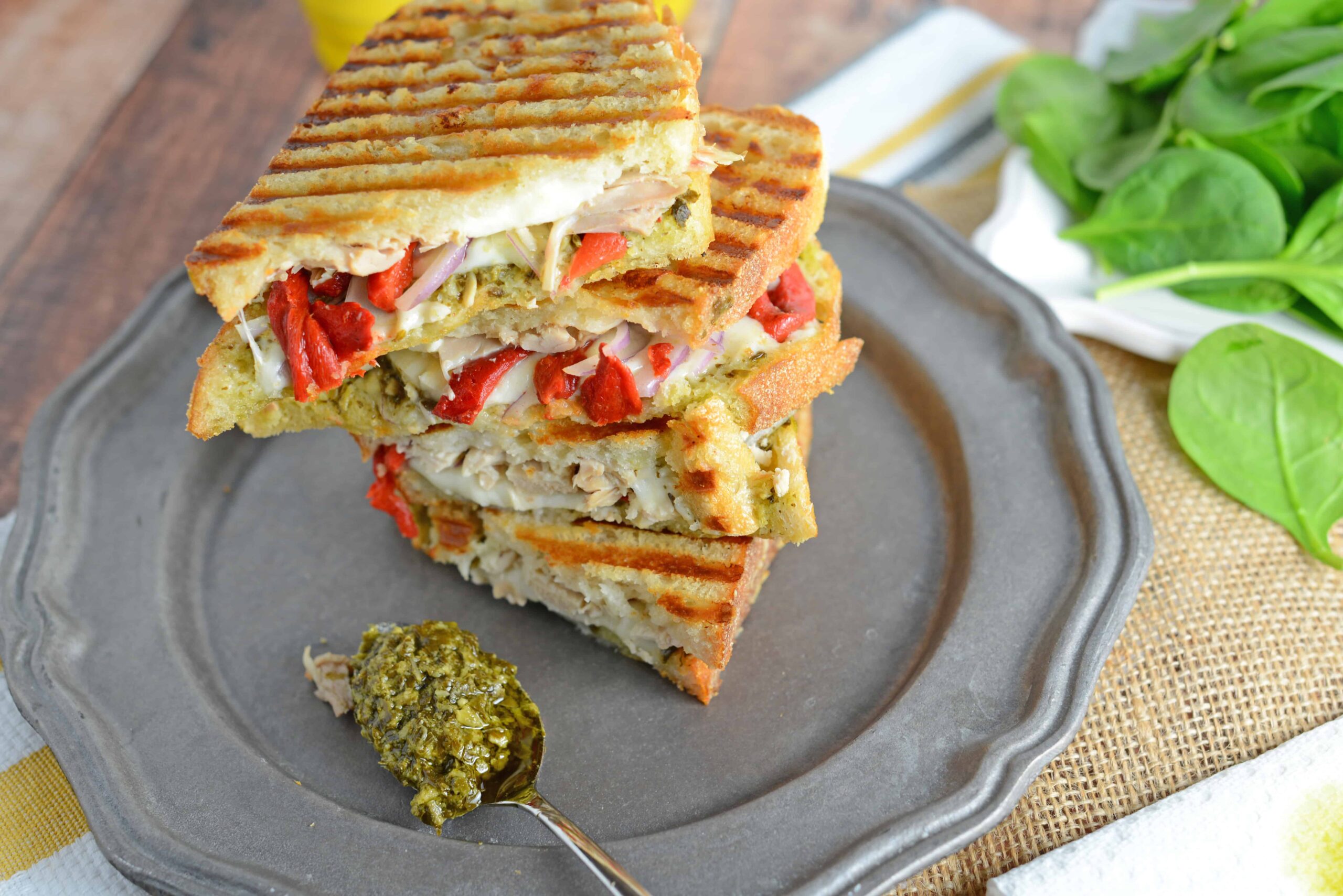 Italian Chicken Panini Recipe - Crusty bread filled with gooey mozzarella cheese, roasted red pepper, shredded chicken and lots and lots of garlicky pesto. www.savoryexperiments.com