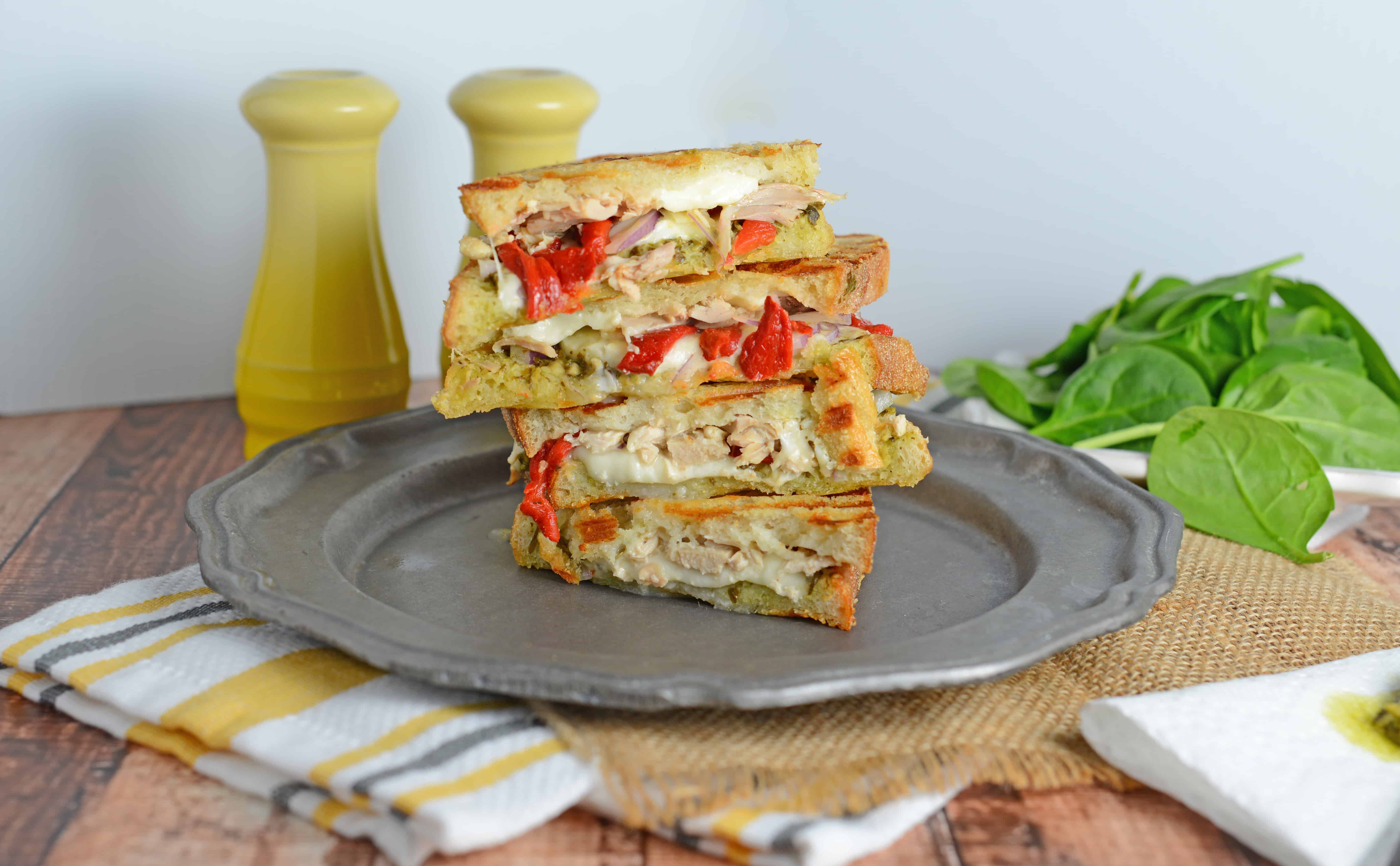 Italian Chicken Panini Recipe - Crusty bread filled with gooey mozzarella cheese, roasted red pepper, shredded chicken and lots and lots of garlicky pesto. www.savoryexperiments.com