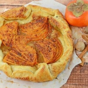 A Persimmon Tart is an easy dessert or breakfast recipe using bright orange persimmon, brown sugar and buttery puff pastry.