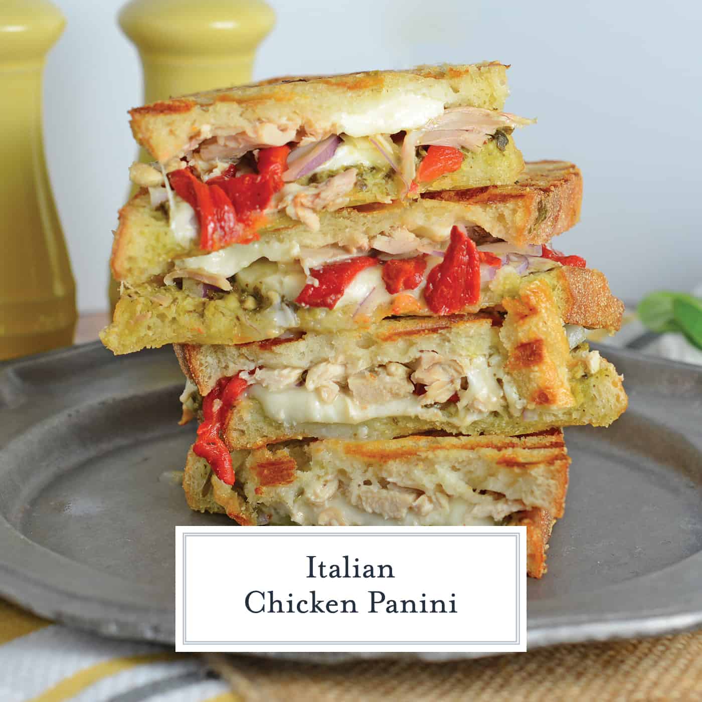 Italian Chicken Panini Recipe is made up of crusty bread filled with gooey mozzarella cheese, roasted red pepper, shredded chicken and lots of garlicky pesto. #chickenpanini #paninirecipe #paninisandwich www.savoryexperiments.com