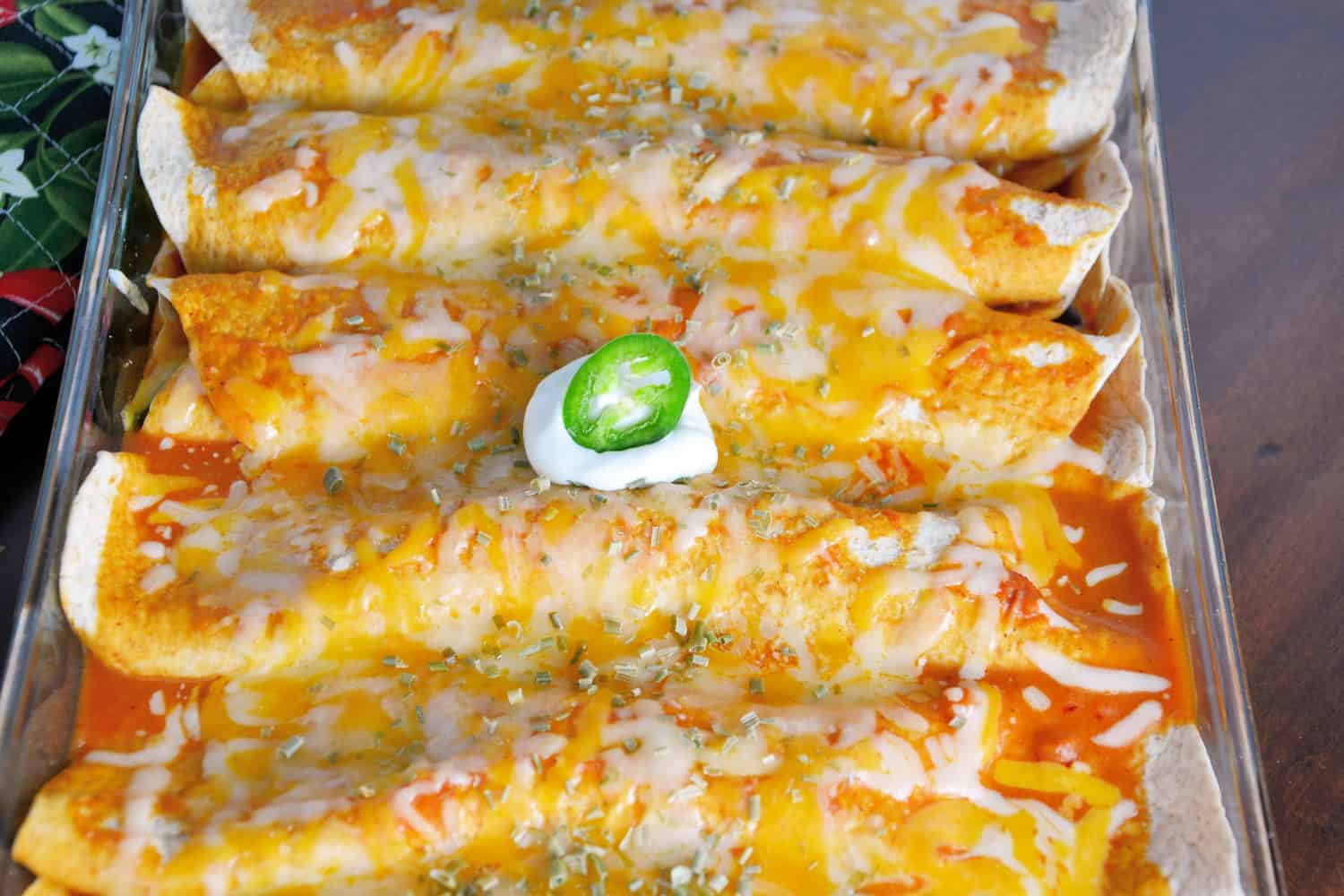 Chicken enchiladas smothered in cheese and red sauce 