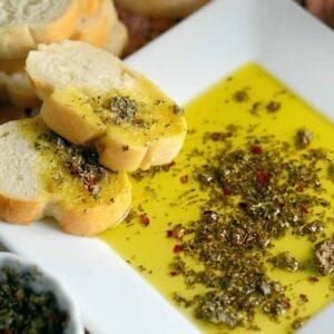 Close up of Copycat Carrabba's Olive Oil Bread Dip on a white plate