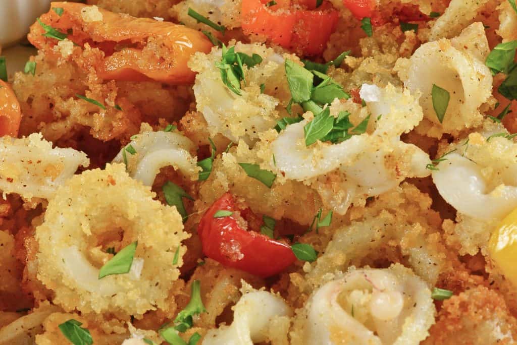 This is the best calamari recipe that you will come across, Fried Calamari are crispy squid fried to golden brown perfection. #easyfriedcalamari #calamarirecipe #calamarifritti www.savoryexperiments.com