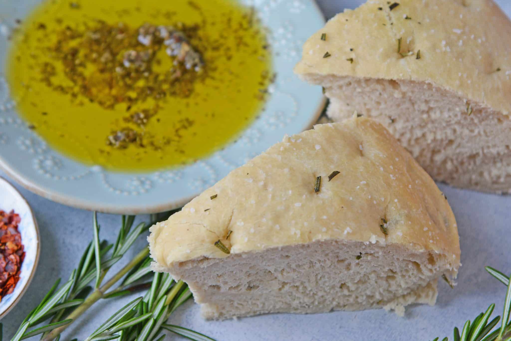 Rosemary Focaccia Bread is a recipe you can be proud of! Pair with homemade butter or olive oil bread dip for the best appetizer.  #focacciabread #easybreadrecipes www.savoryexperiments.com