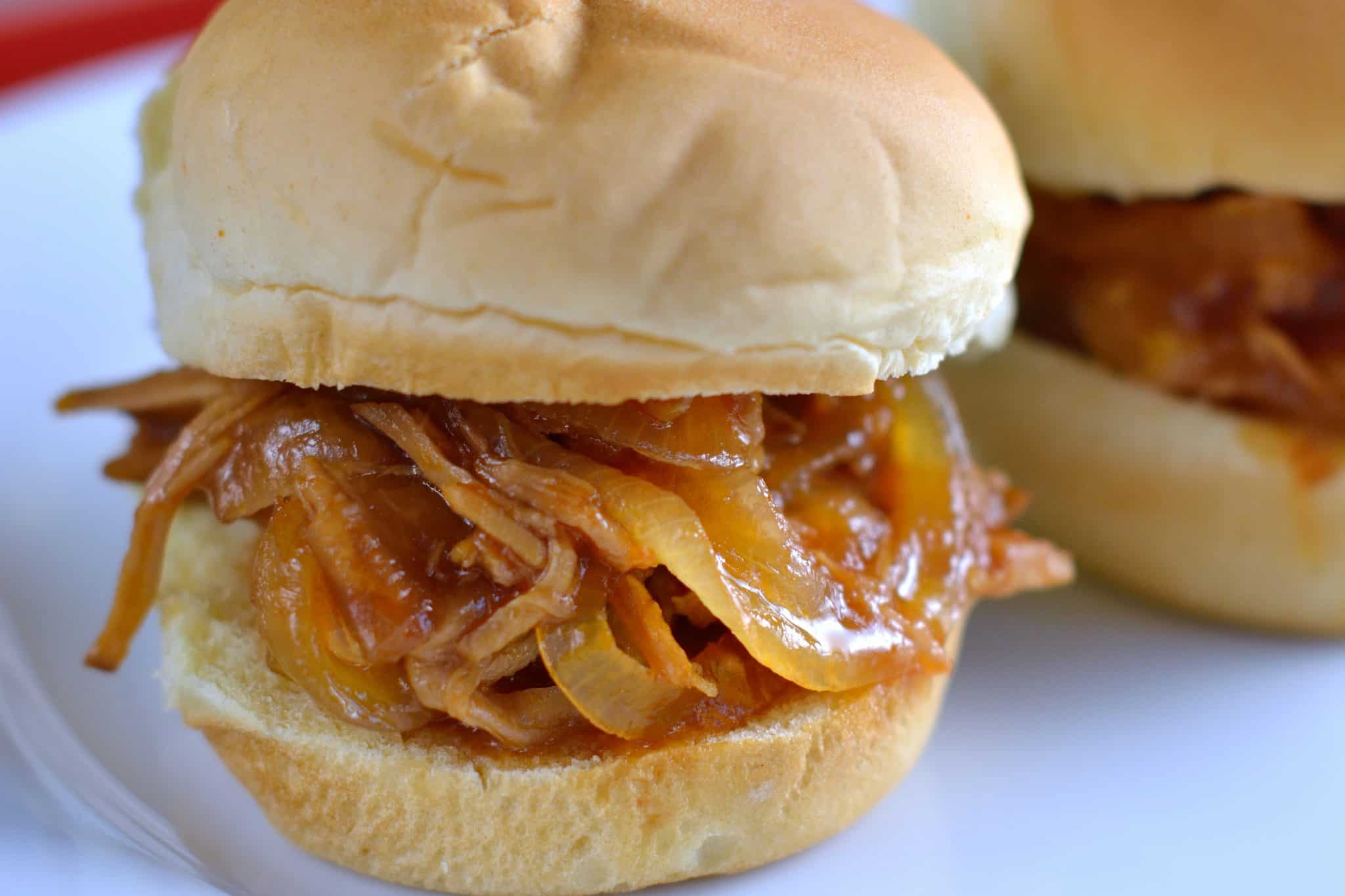 This set it and forget it Pineapple Slow Cooker Pulled Pork is the perfect family meal during a busy week. All it takes is 10 minutes of prep time! #crockpotpulledpork #pulledporksandwiches www.savoryexperiments.com