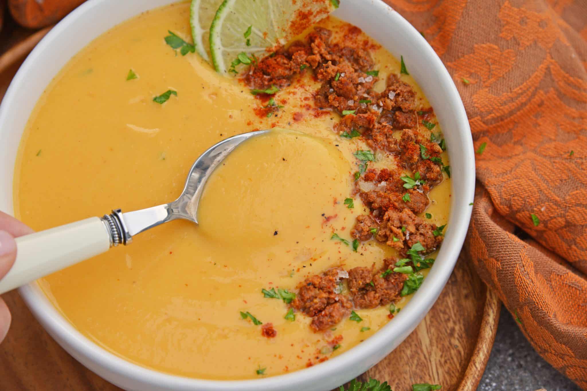 Spicy Sweet Potato Soup is a healthy blend of vegetables with a sweet and spicy kick! This soup definitely falls under the category of easy soup recipes! #sweetpotatosoup #easysouprecipes #sweetpotatorecipes www.savoryexperiments.com