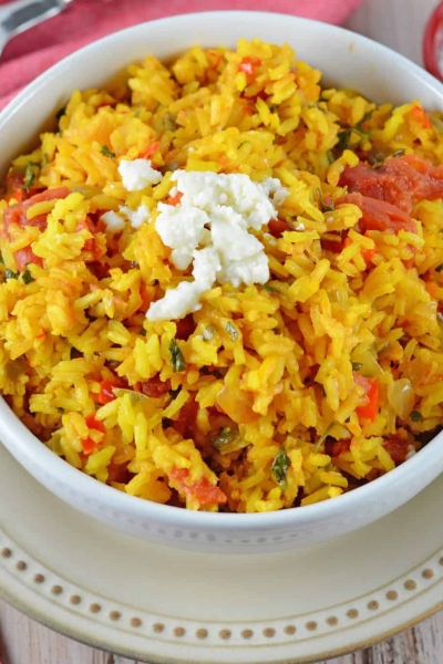 Mexican Rice is a zesty side dish recipe packed with vegetables and flavor. Serve with your favorite Mexican recipes, inside burritos or as its own dish.