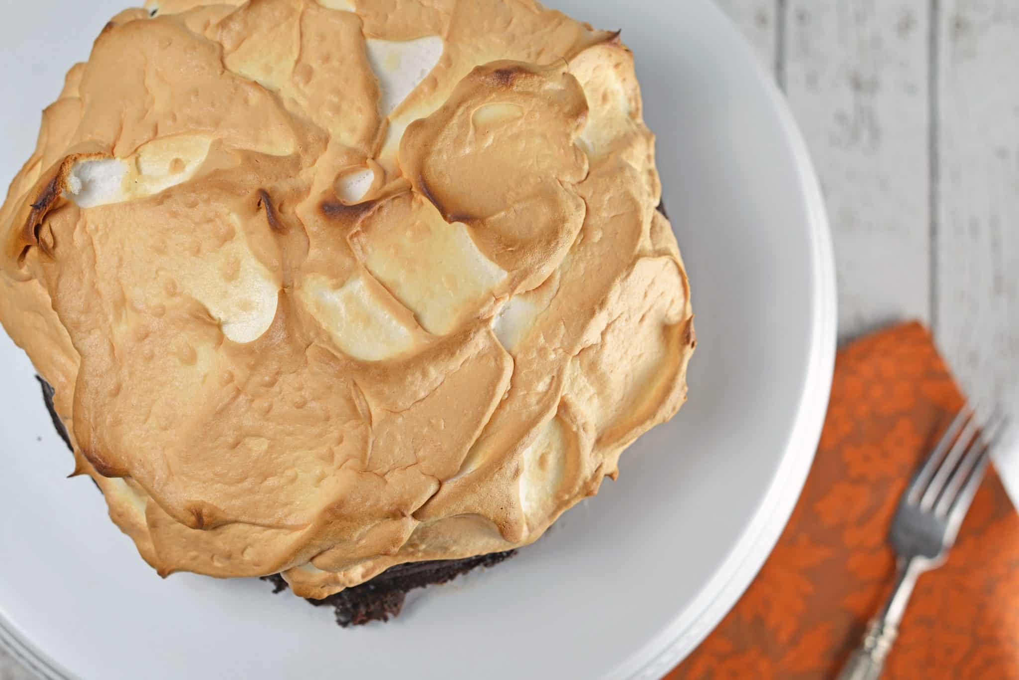 Chocolate Guinness Cake is a super rich and moist cake with fluffy meringue topping. This flourless chocolate cake is perfect for St. Patrick's Day dessert or any other day of the year! #chocolateguinnesscake #flourlesschocolatecake www.savoryexperiments.com