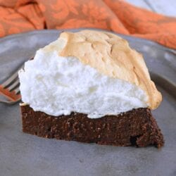 Chocolate Guinness Cake is a super rich and moist cake with fluffy meringue topping. This flourless chocolate cake is perfect for St. Patrick's Day dessert or any other day of the year! #chocolateguinnesscake #flourlesschocolatecake www.savoryexperiments.com