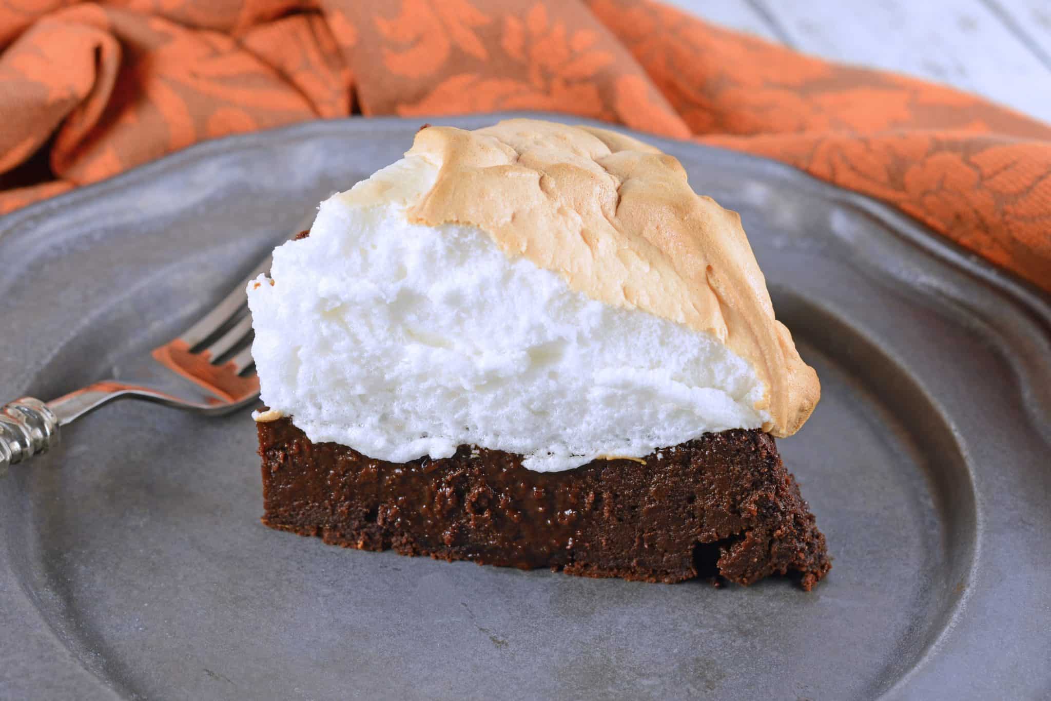 Chocolate Guinness Cake is a super rich and moist cake with fluffy meringue topping. This flourless chocolate cake is perfect for St. Patrick's Day dessert or any other day of the year! #chocolateguinnesscake #flourlesschocolatecake www.savoryexperiments.com