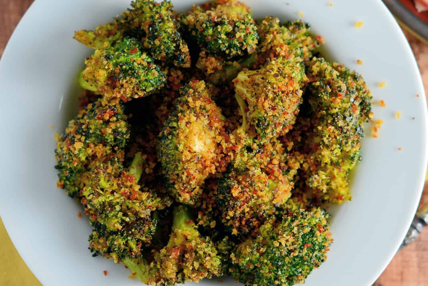 Crunchy baked broccoli tossed in a crisp, tangy mix with two secret ingredients that will make this broccoli recipe your favorite side dish! #bakedbroccoli #ovenbakedbroccoli www.savoryexperiments.com 