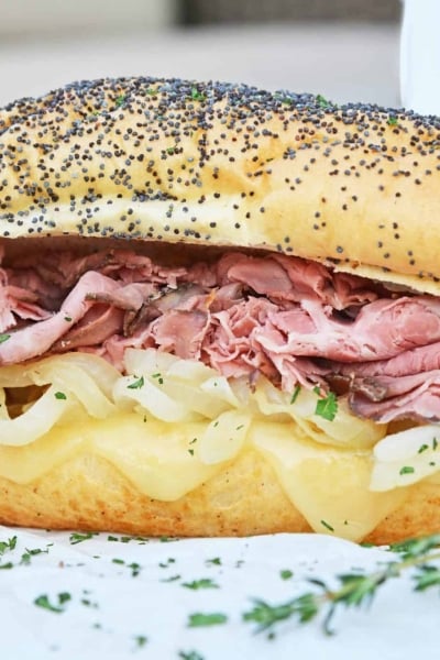 Easy French Dip Sandwiches are made from tender roast beef with caramelized onions, roasted garlic, whipped horseradish cream sauce on brioche rolls! #roastbeefsandwich #frenchdipsandwiches www.savoryexperiments.com