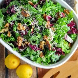 Kale Salad Recipe-tossed with currants, radicchio, walnuts and a lemon dressing. Find out my secret tips on making your kale salads silky smooth and how to make kale chips with the leftovers! www.savoryexperiments.com
