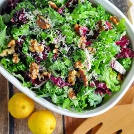 Kale Salad Recipe-tossed with currants, radicchio, walnuts and a lemon dressing. Find out my secret tips on making your kale salads silky smooth and how to make kale chips with the leftovers! www.savoryexperiments.com