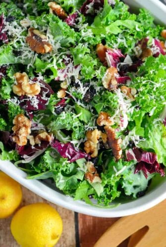 Kale Salad Recipe-tossed with currants, radicchio, walnuts and a lemon dressing. Find out my secret tips on making your kale salads silky smooth and how to make kale chips with the leftovers! www.savoryexperiments.com