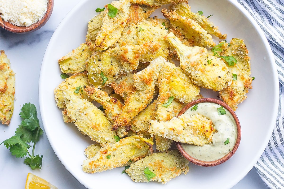 serving plate of artichoke hearts and dipping sauce