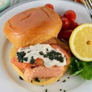 The Ultimate Salmon Sandwich is the best salmon sandwich because it uses two types of salmon with dilled sour cream and caviar on a buttery brioche roll.