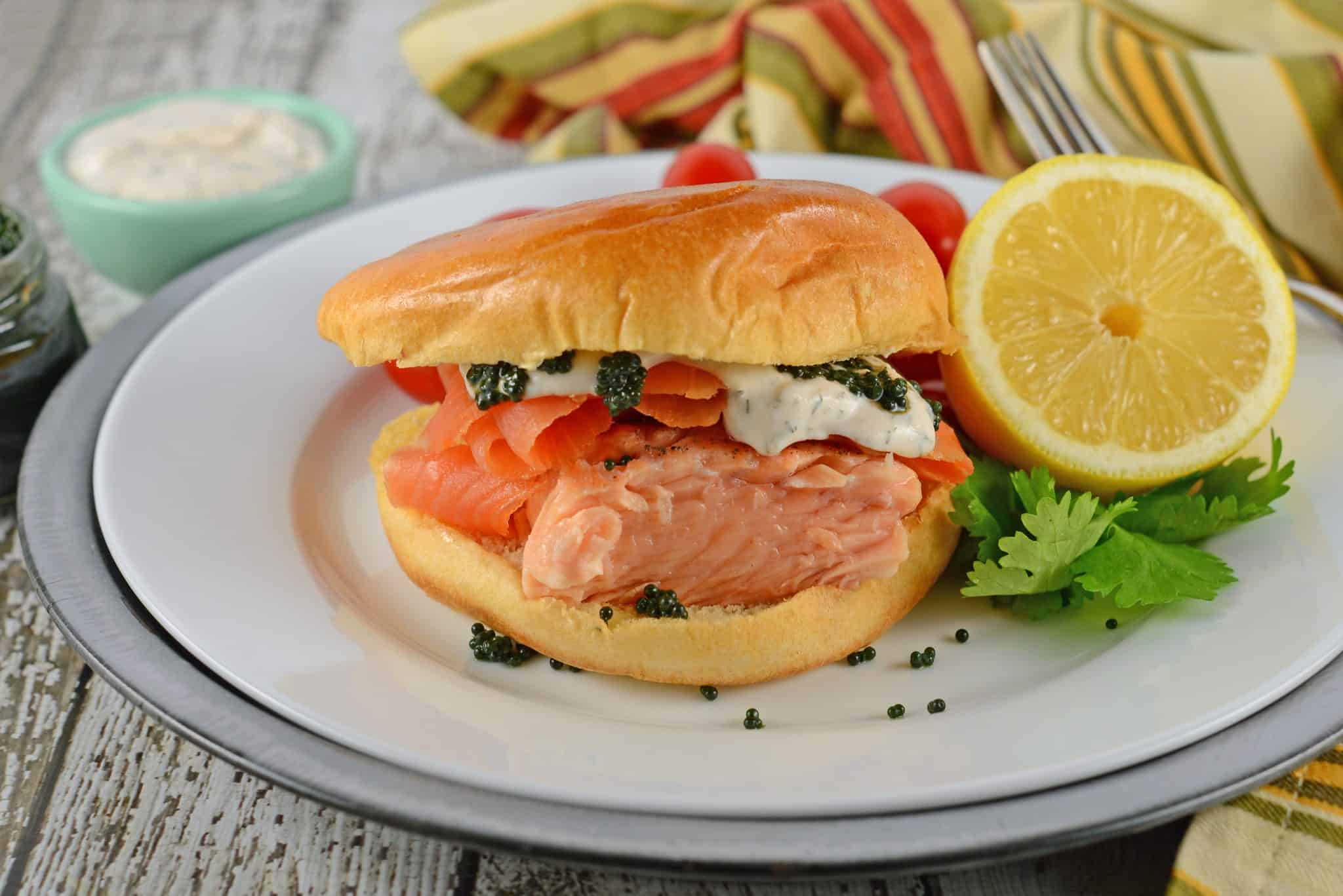 The Ultimate Salmon Sandwich is the best salmon sandwich because it uses two types of salmon with dilled sour cream and caviar on a buttery brioche roll.