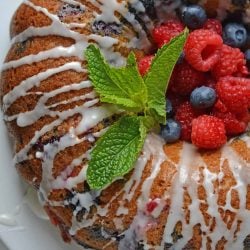 berry buttermilk bundt cake with glaze and fresh mint