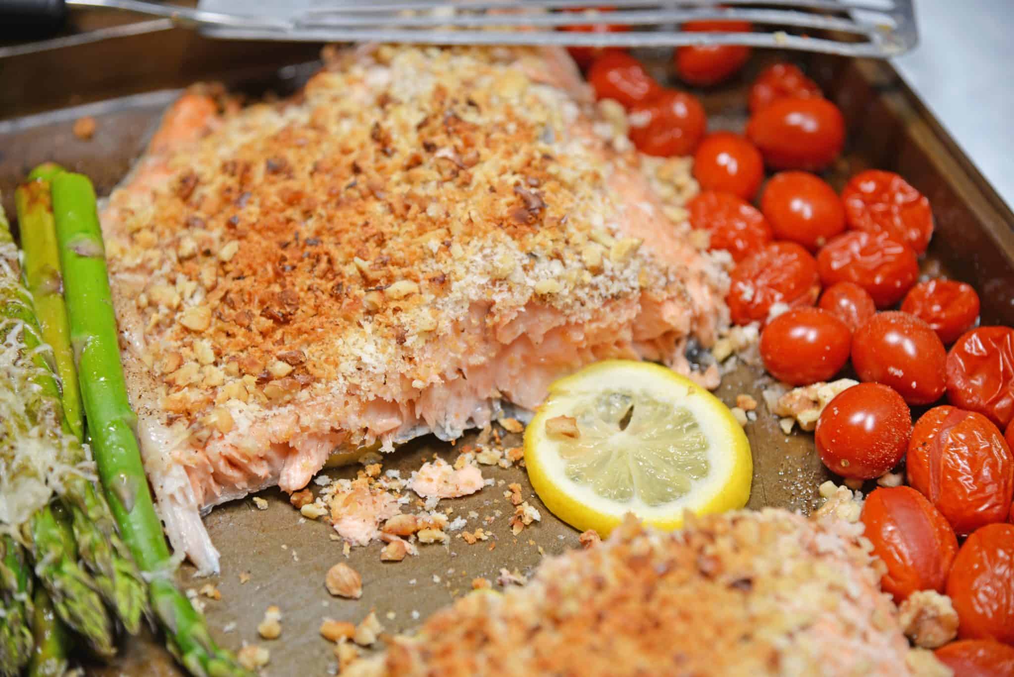 Sheet Pan Crispy Salmon is a fast, easy and healthy weeknight meal. Prep this sheet pan meal in just 5 minutes using tomatoes, asparagus and a crispy panko and walnut topping for you salmon.