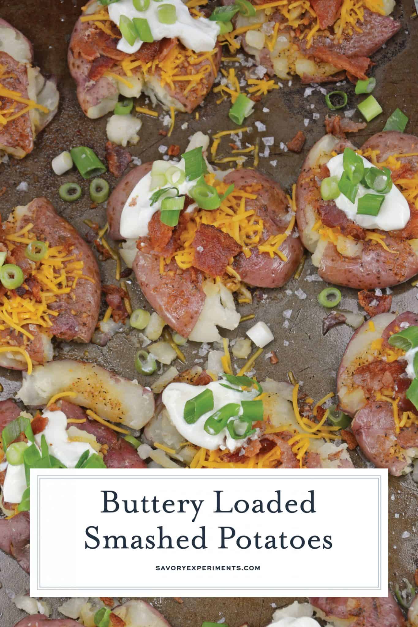 Loaded Smashed Potatoes are a cross between a loaded baked potato and loaded mashed potatoes. Topped with a zesty butter sauce, cheese, bacon, sour cream and scallions. #smashedpotatoes #potatorecipes www.savoryexperiments.com