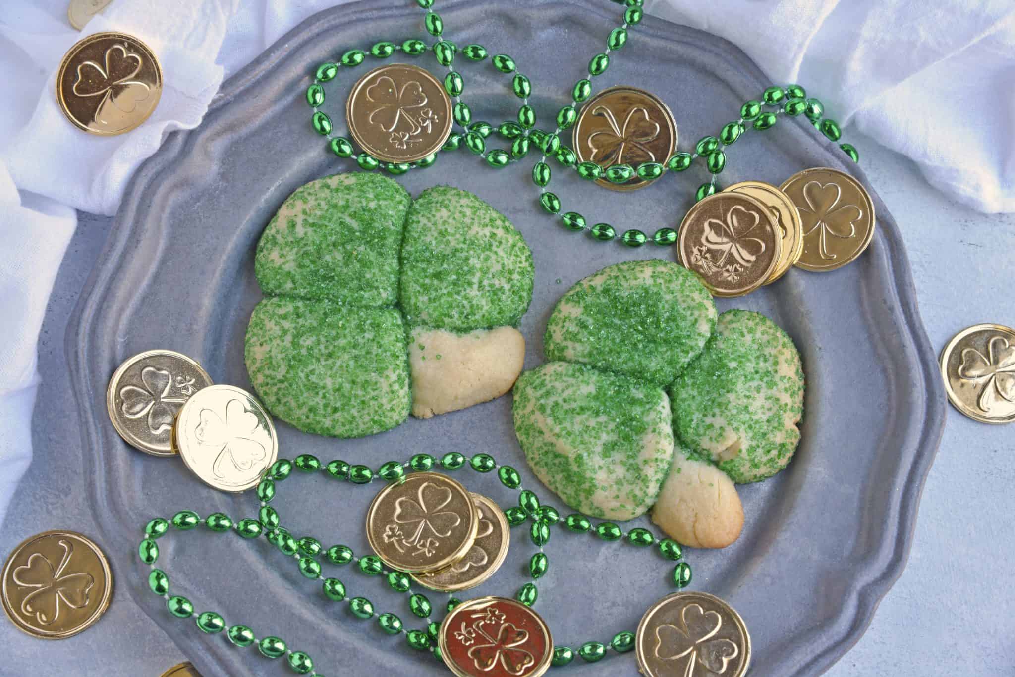 Sugar Cookie Shamrocks bring the luck of the Irish with them. St. Patrick's Day cookies creatively molded to make green lucky clovers, a great St. Patrick's Day dessert recipe. #stpatricksdayfood #stpatricksdaydessert www.savoryexperiments.com