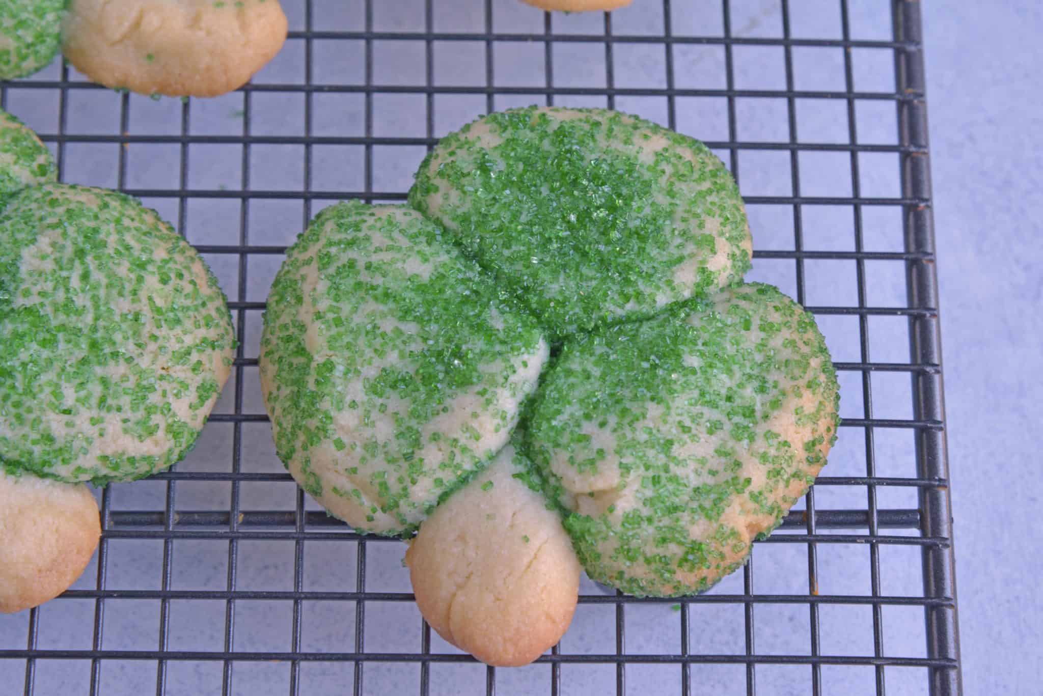 Sugar Cookie Shamrocks bring the luck of the Irish with them. St. Patrick's Day cookies creatively molded to make green lucky clovers, a great St. Patrick's Day dessert recipe. #stpatricksdayfood #stpatricksdaydessert www.savoryexperiments.com