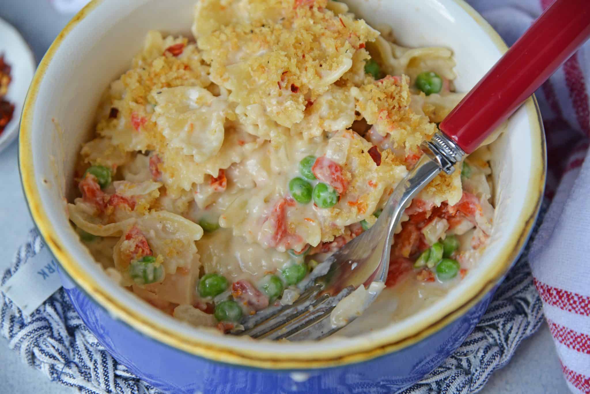 Fancy Tuna Noodle Casserole comes packed with bow tie pasta, seasoned panko, fresh vegetables and sun dried tomatoes! #tunanoodlecasserolerecipe #easytunanoodlecasserole www.savoryexperiments.com