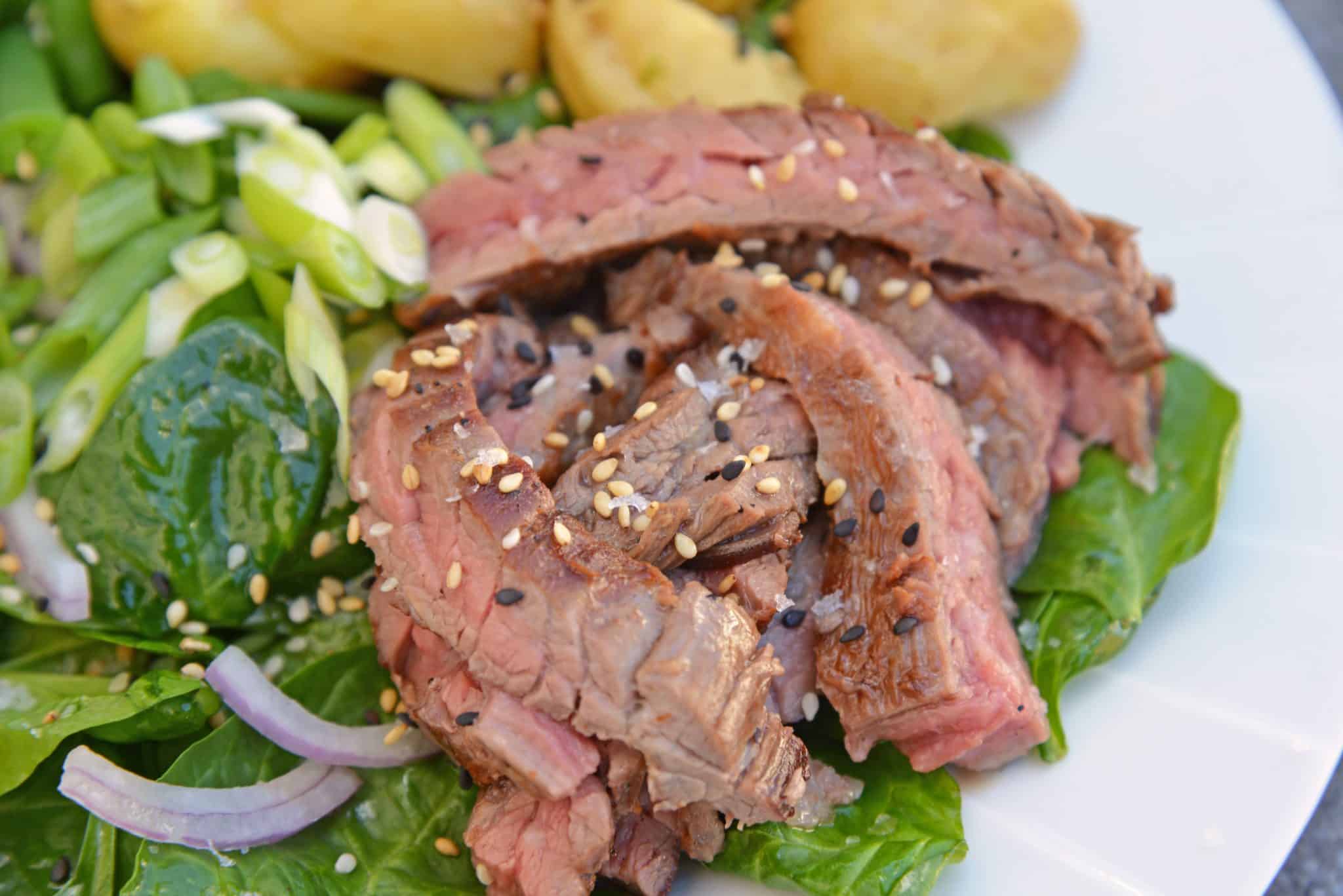 Skirt Steak Salad - an easy and healthy dinner solution that uses 6 ingredients and a simple homemade miso ginger dressing. The only steak salad recipe you need! #steaksaladrecipe #skirtsteaksalad www.savoryexperiments.com