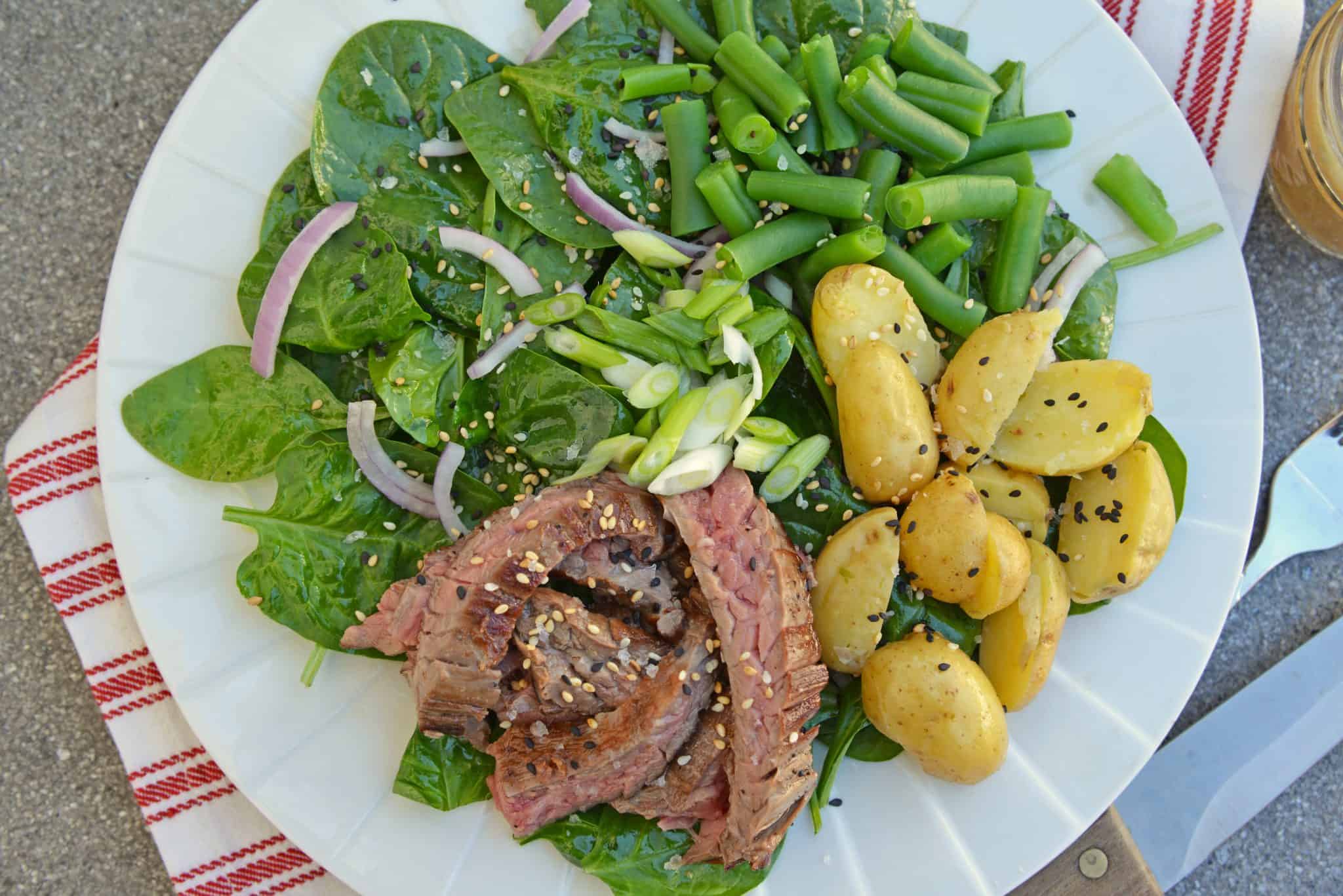 Skirt Steak Salad - an easy and healthy dinner solution that uses 6 ingredients and a simple homemade miso ginger dressing. The only steak salad recipe you need! #steaksaladrecipe #skirtsteaksalad www.savoryexperiments.com