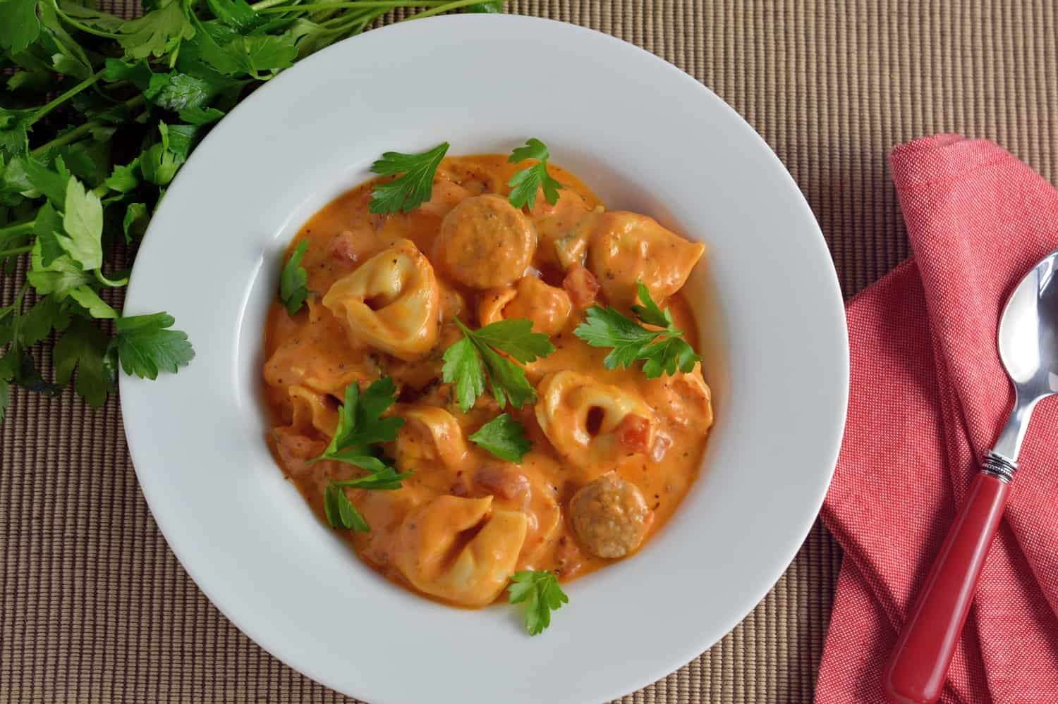 Creamy Tortellini and Sausage Soup can be made in the slow cooker, instant pot or on the stove top. Cheesy tortellini with zesty sauce in a tomato based soup! 