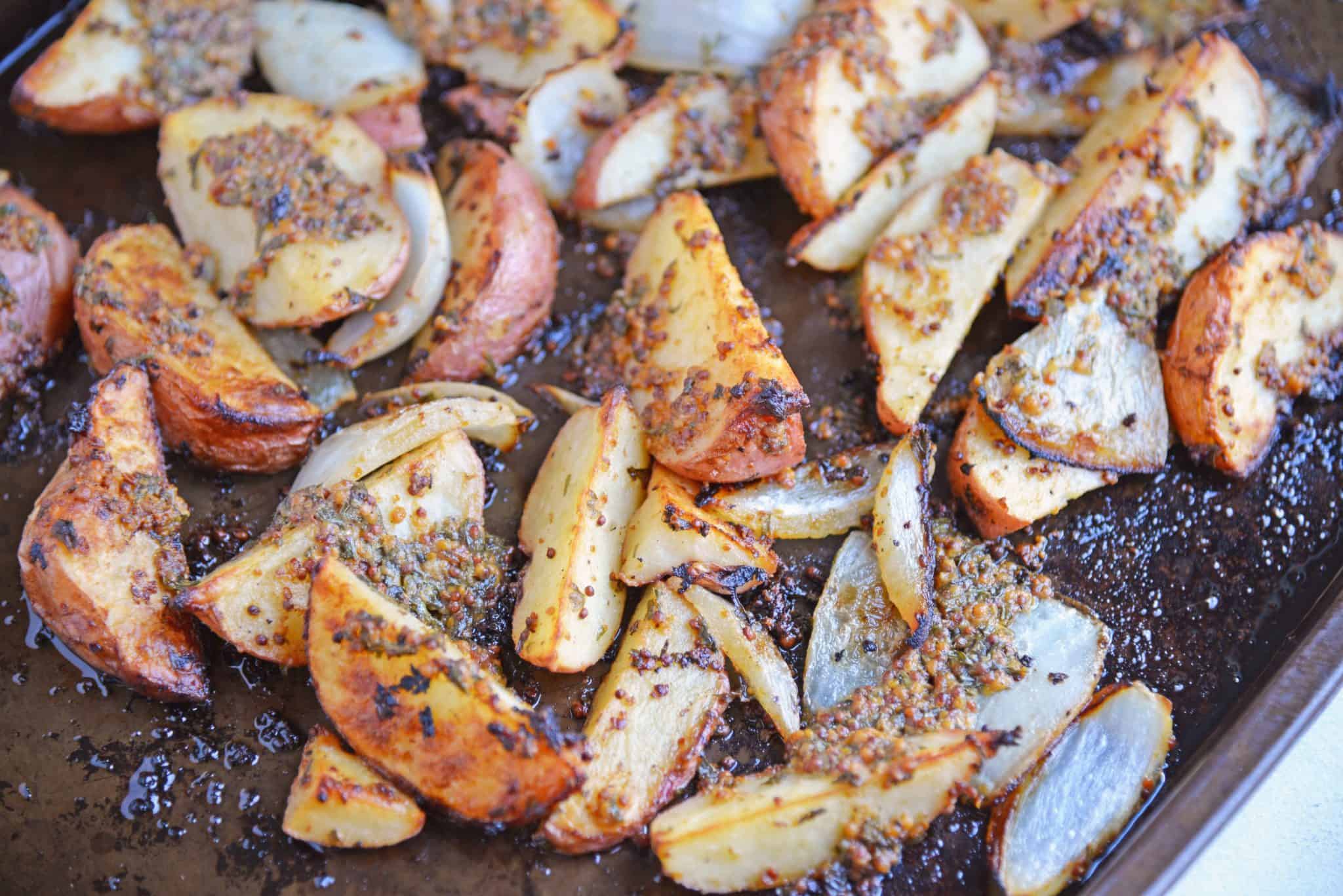 This Dijon Roasted Potatoes recipe is the perfect potato side dish to serve alongside chicken or steak! These oven roasted potatoes are packed full of flavor! #ovenroastedpotatoes #roastedpotatoesrecipe www.savoryexperiments.com