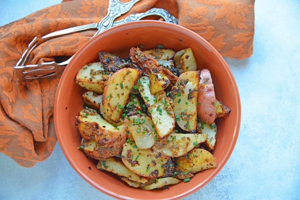 This Dijon Roasted Potatoes recipe is the perfect potato side dish to serve alongside chicken or steak! These oven roasted potatoes are packed full of flavor! #ovenroastedpotatoes #roastedpotatoesrecipe www.savoryexperiments.com