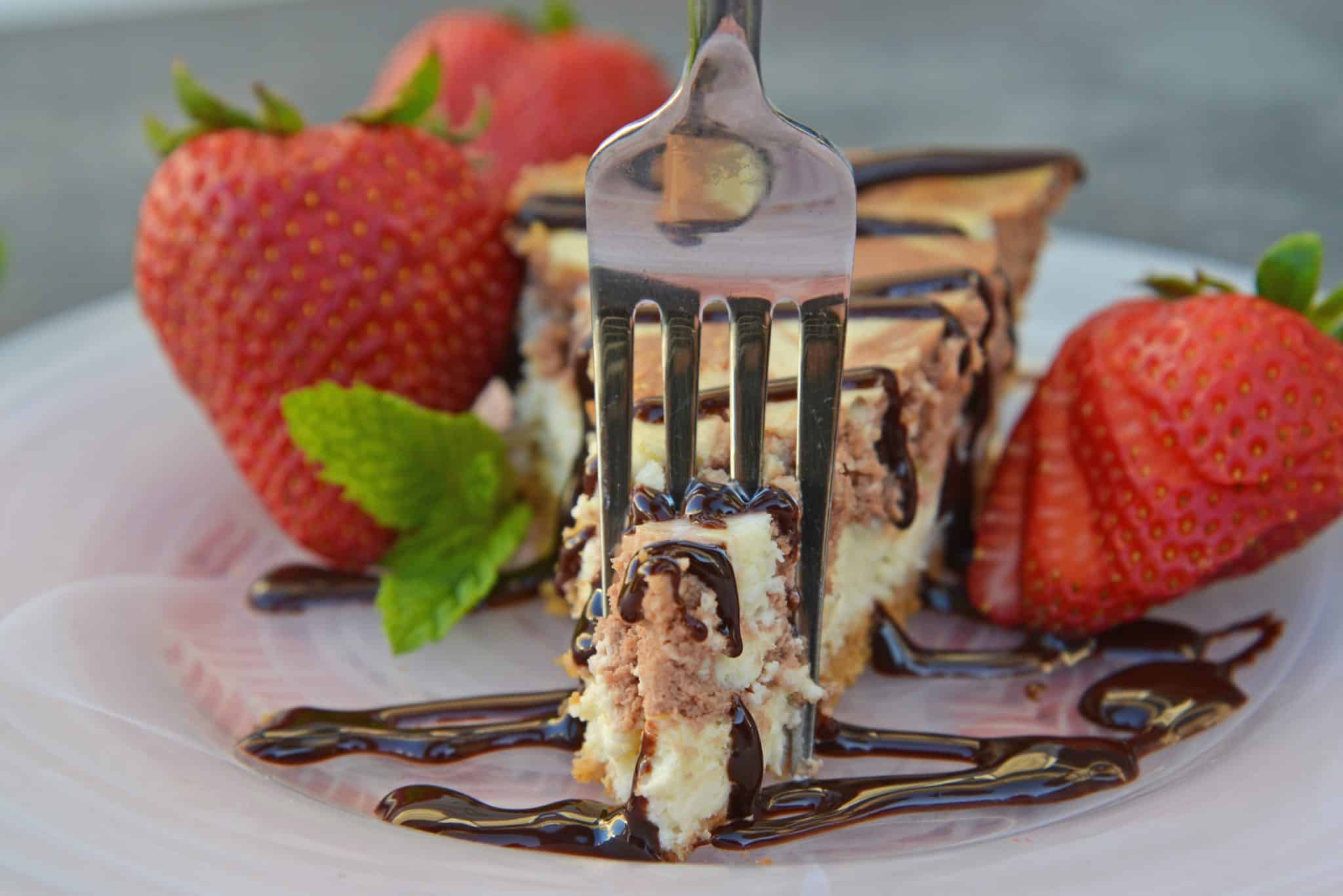 Marble New York Cheesecake is one of the best cheesecake recipes you'll ever come across! This dessert is a thicker but deliciously creamy cheesecake recipe! #newyorkstylecheesecake #bestcheesecakerecipes www.savoryexperiments.com