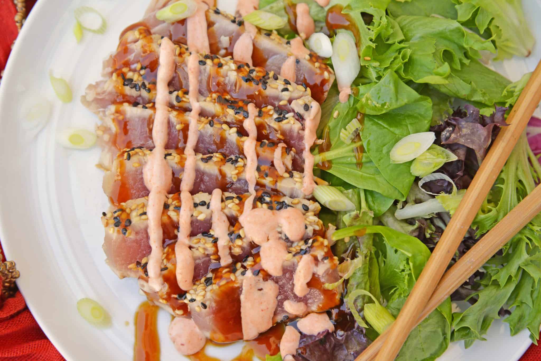 Teriyaki Ahi Tuna on a white plate with leafy greens