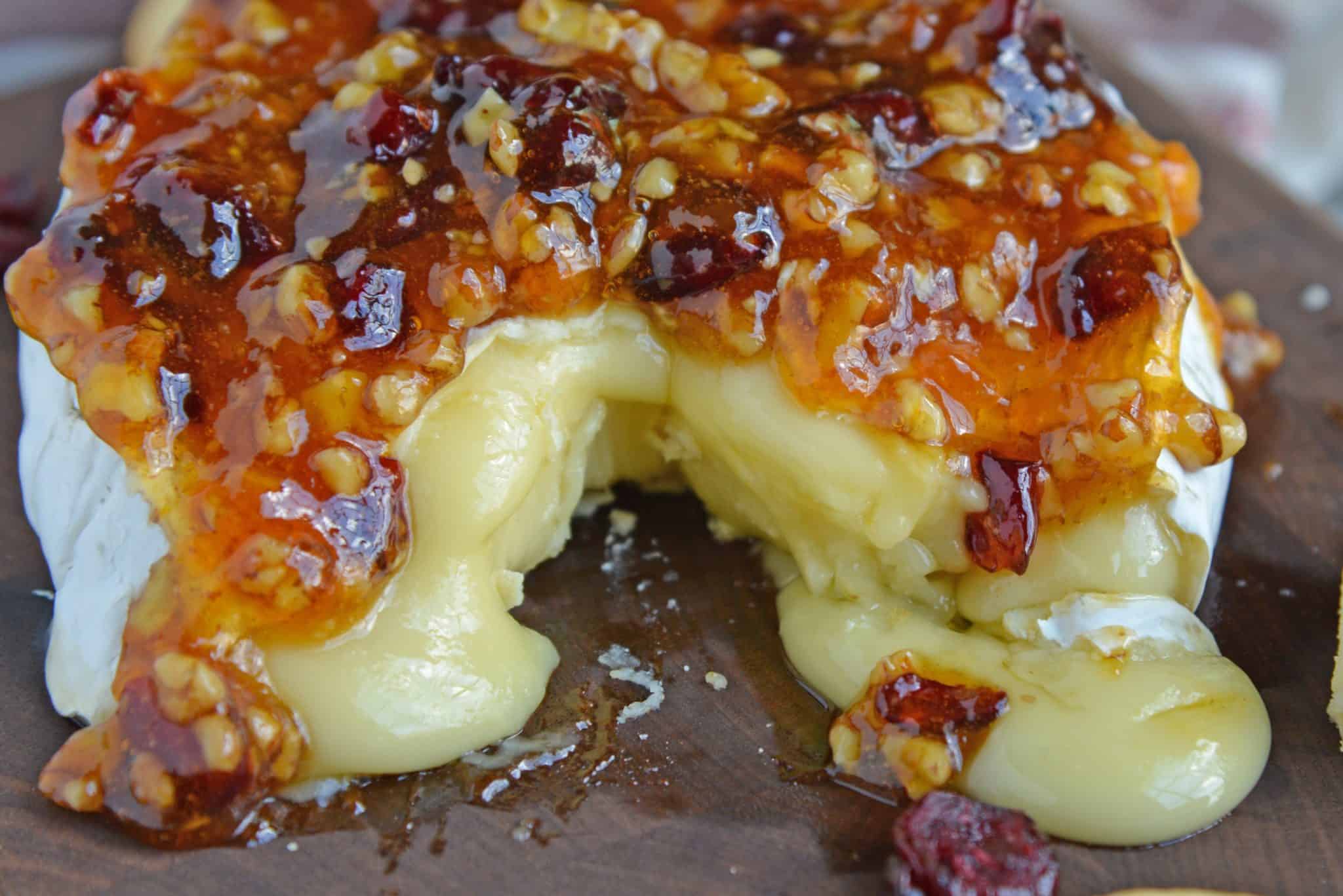 Apricot Cranberry Baked Brie is the ultimate appetizer. This baked brie appetizer will be perfect for any occasion. #bakedbrierecipe #bakedbrieappetizer www.savoryexperiments.com