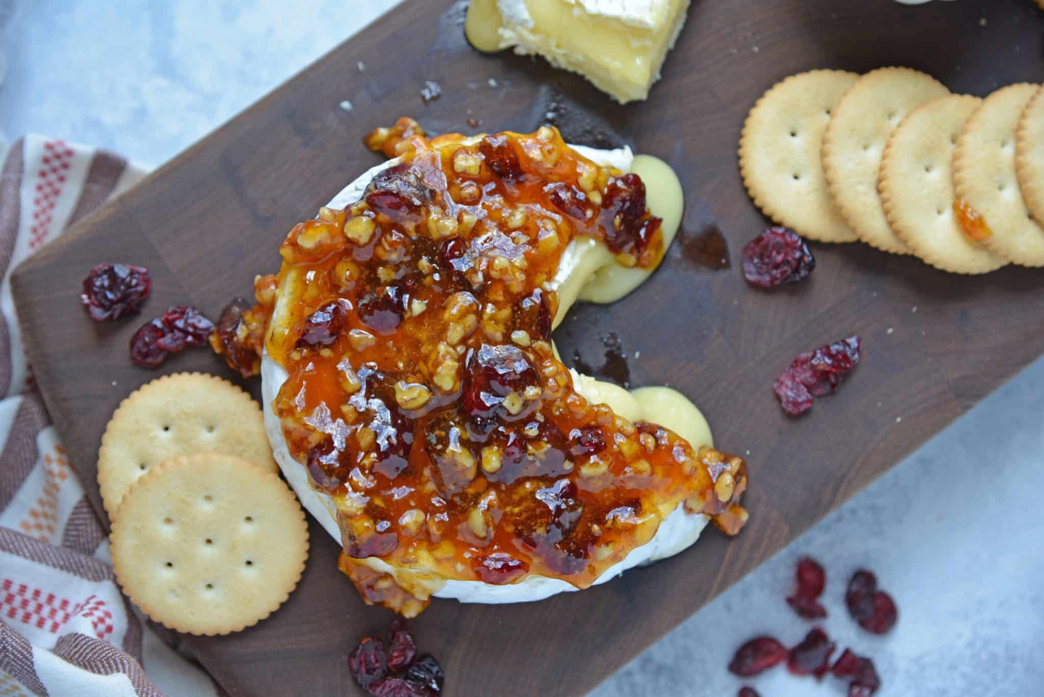 Apricot Cranberry Baked Brie is the ultimate appetizer. This baked brie appetizer will be perfect for any occasion. #bakedbrierecipe #bakedbrieappetizer www.savoryexperiments.com