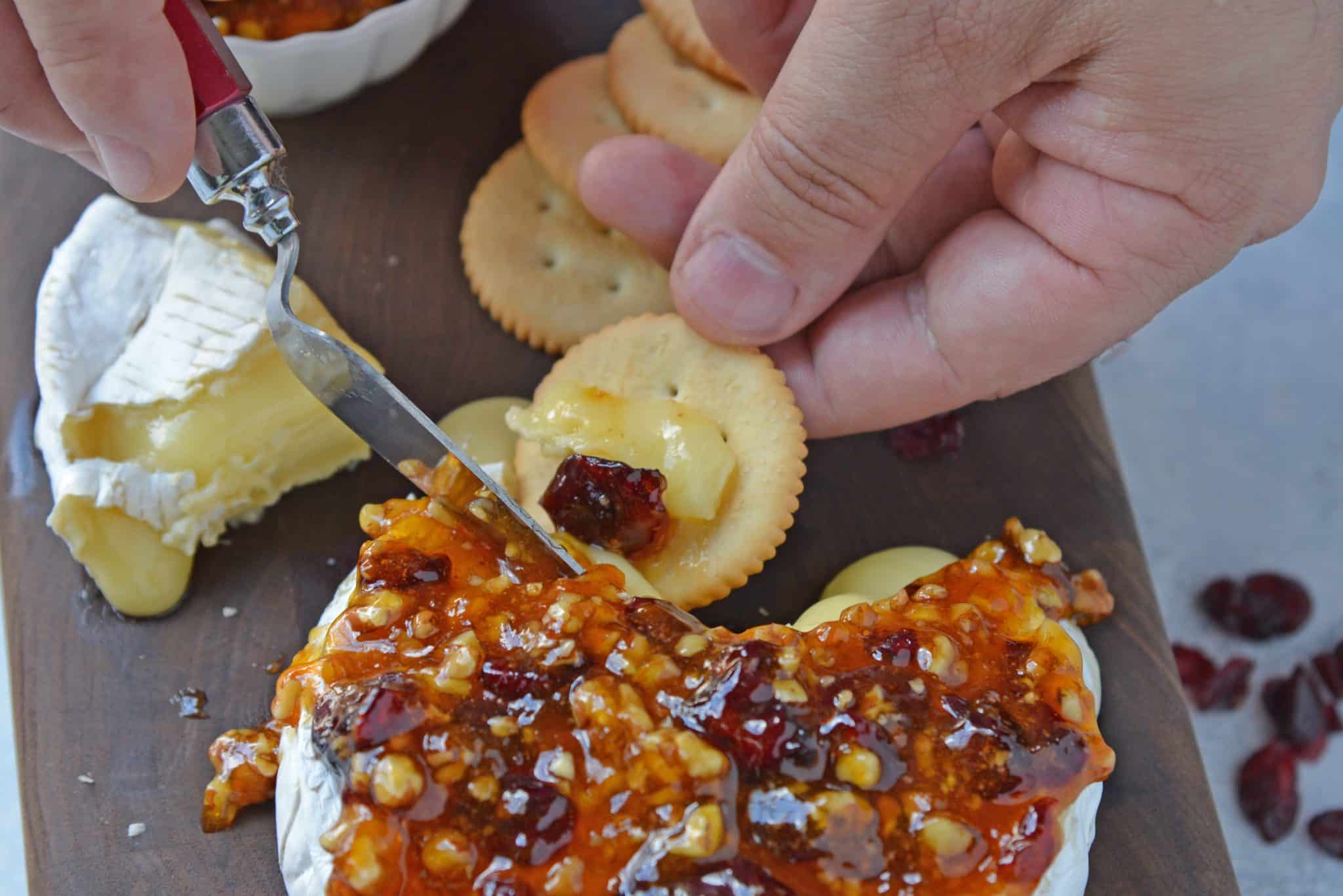 Apricot Cranberry Baked Brie is the ultimate appetizer. This baked brie appetizer will be perfect for any occasion. #bakedbrierecipe #bakedbrieappetizer www.savoryexperiments.com