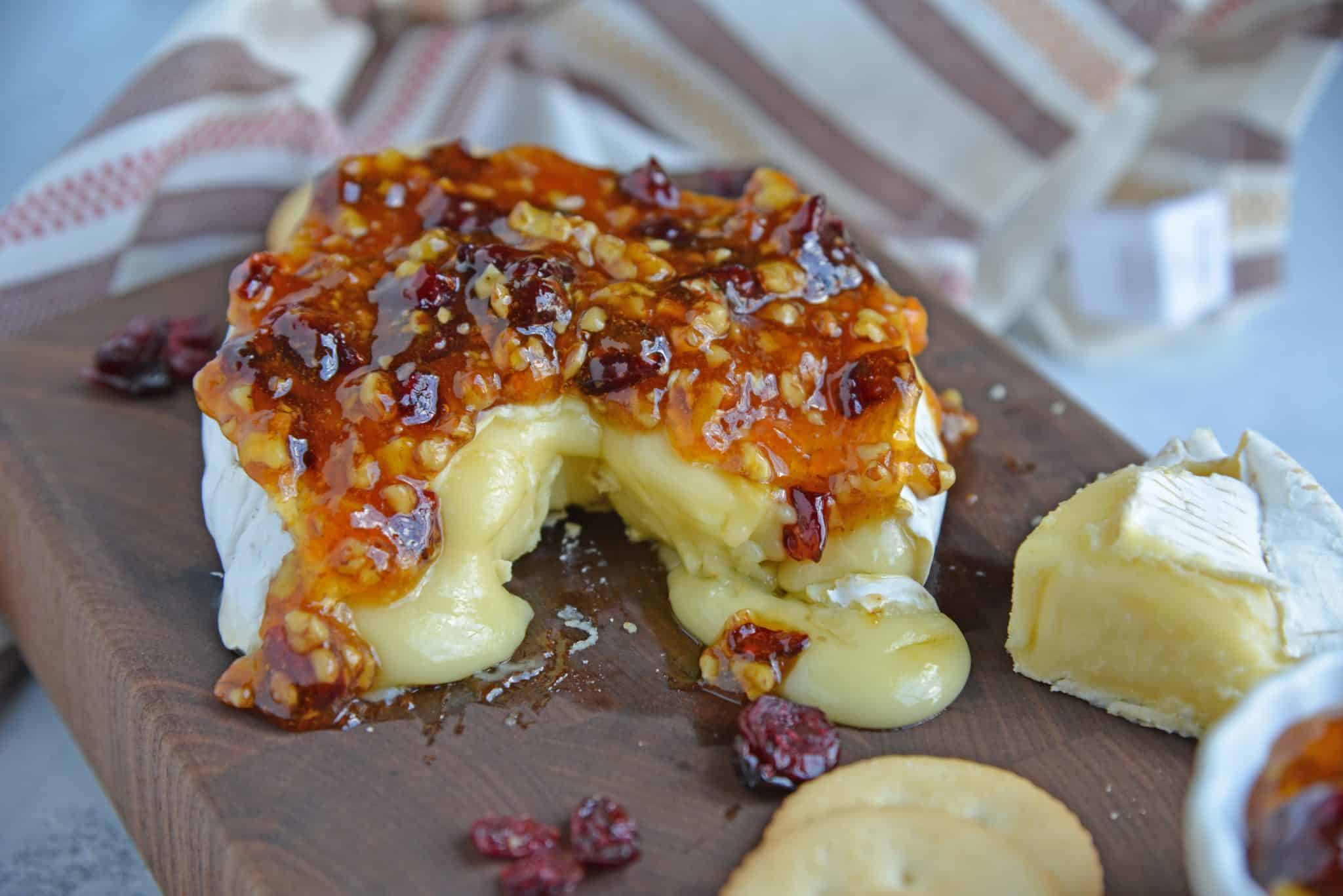 Apricot Cranberry Baked Brie is the ultimate appetizer. This baked brie appetizer will be perfect for any occasion. #bakedbrierecipe #bakedbrieappetizer www.savoryexperiments.com