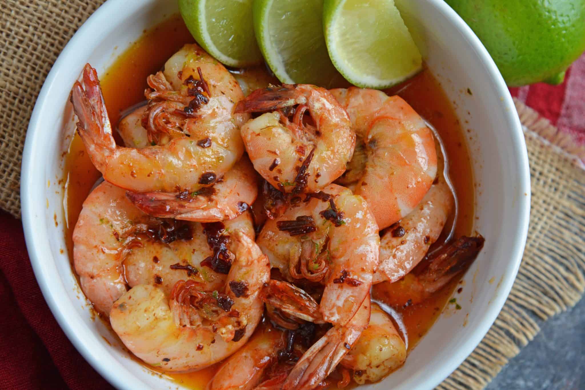 shrimp in a bowl of chipotle butter with fresh limes
