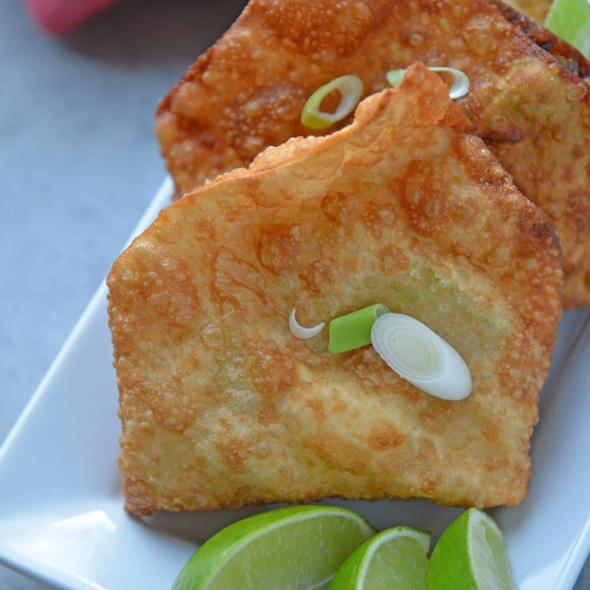 Avocado and Crab Rangoons are one of my favorite appetizer recipes! Creamy avocado, buttery crab and lush cream cheese with a Jalapeno Pineapple Sauce. #crabrangoons www.savoryexperiments.com