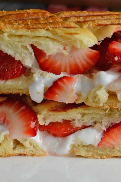 delicious dessert sandwich with croissant, fluff, fruit and dulce de leche