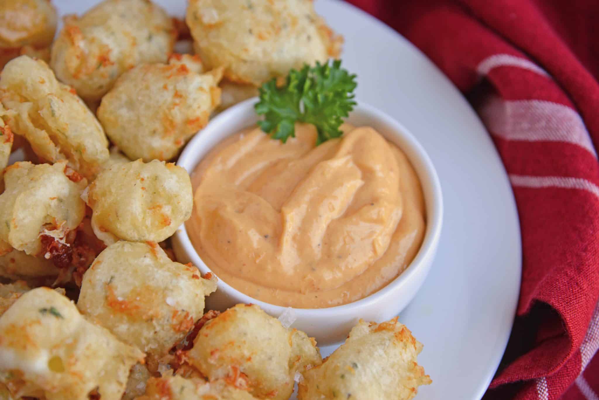 Fried Cheese Curds, also known as Beer Battered Cheese Curds, as the perfect fried cheese balls! Gooey little nuggets paired with a tangy dipping sauce served as an easy appetizer. #friedcheese #friedcheesecurds www.savoryexperiments.com