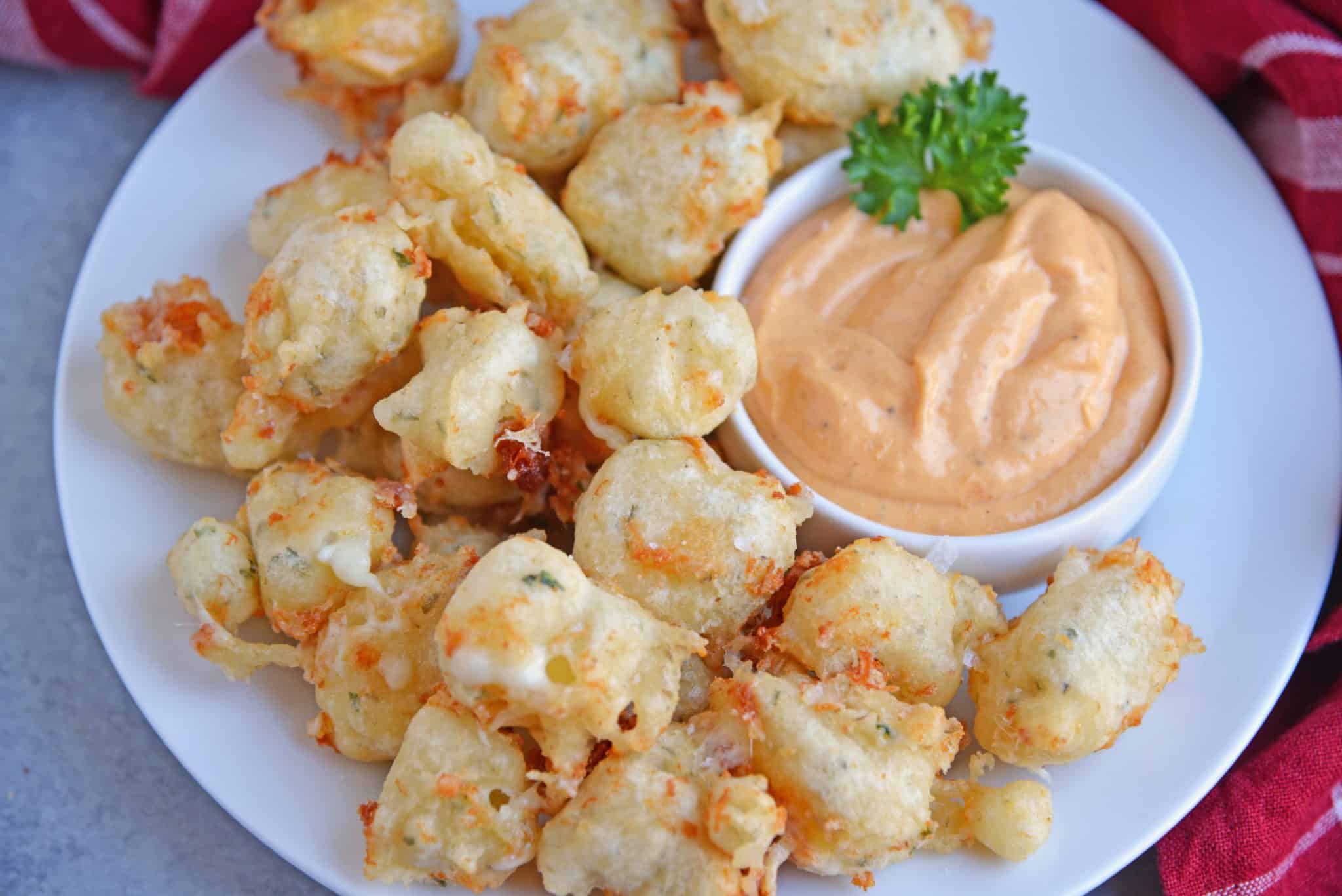 Fried Cheese Curds, also known as Beer Battered Cheese Curds, as the perfect fried cheese balls! Gooey little nuggets paired with a tangy dipping sauce. A great easy appetizer for snack idea! 