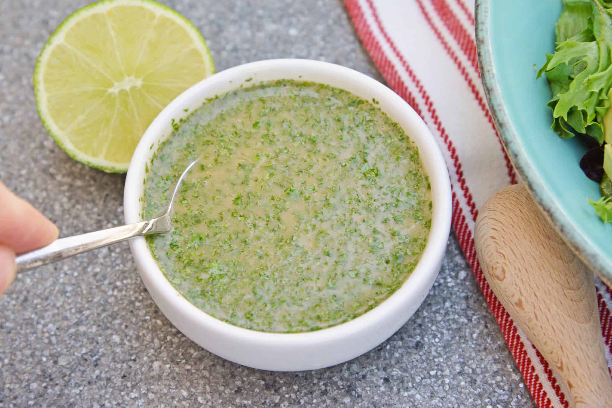 Cilantro Lime Dressing is an easy and delicious citrus dressing for salads, dipping sauces or even as a marinade! Spicy and sweet, it is no-cook and comes together in 5 minutes. #homemadesaladdressing www.savoryexperiments.com