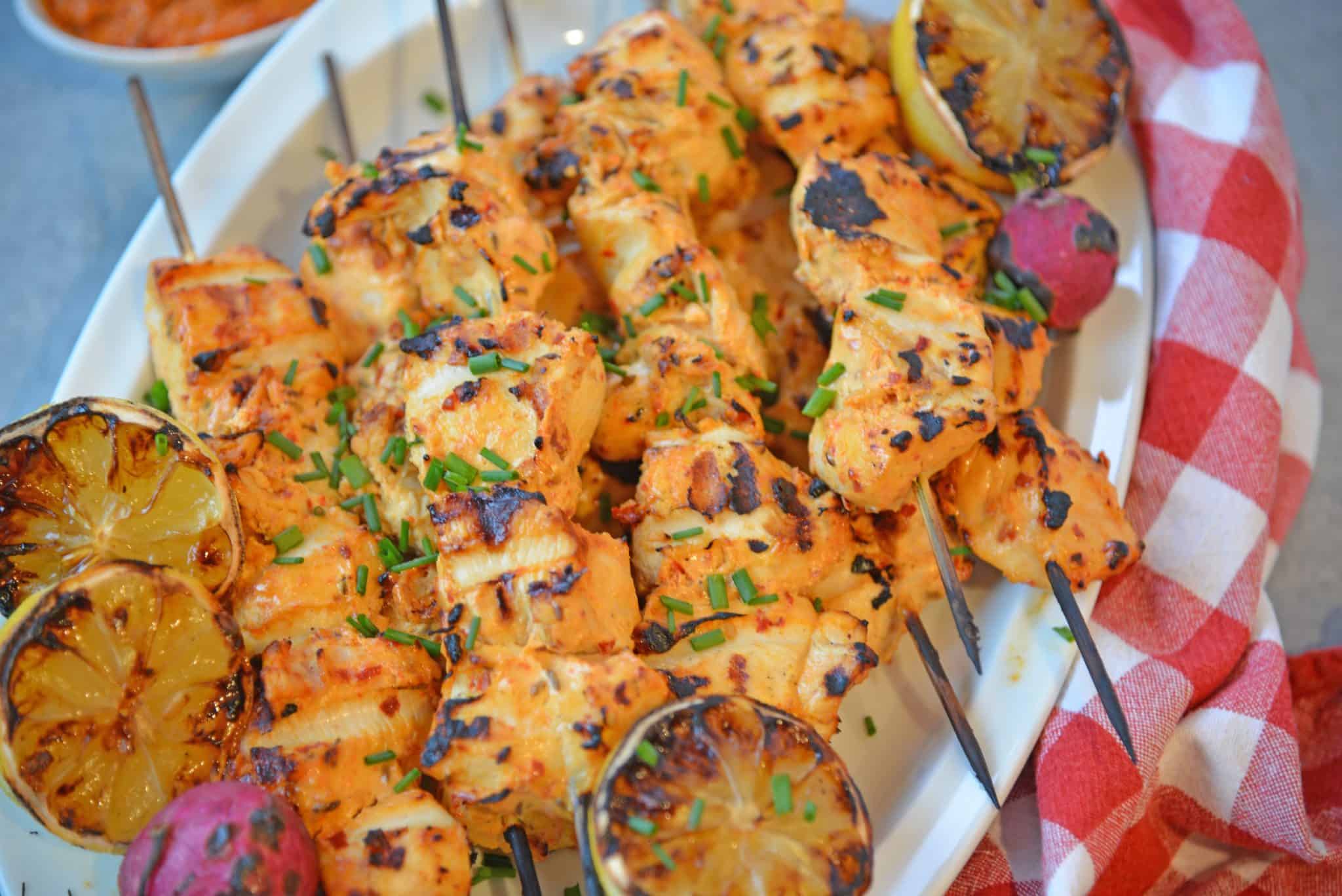 Harissa Chicken Kabobs use the spiciness of harissa paste and the coolness of Greek yogurt to make tender chicken on the grill. #chickenkabobs #grilledchicken www.savoryexperiments.com